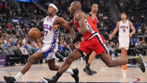 Los Angeles Clippers guard Kris Dunn (8) pressures Philadelphia 76ers guard Vj Edgecombe (77) during the first half of an NBA basketball game Monday, Feb. 2, 2026, in Inglewood, Calif. (AP Photo/Jae C. Hong)