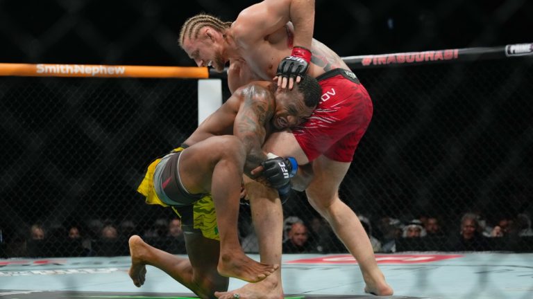 Russia's Alexander Volkov defends a takedown attempt from Brazil's Jailton Almeida during a UFC heavyweight bout. (Altaf Qadri/AP)