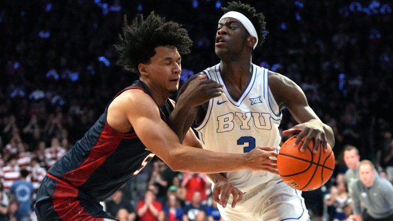 BYU forward AJ Dybantsa (3) drives on Arizona guard Brayden Burries during the first half of an NCAA college basketball game, Wednesday, Feb. 18, 2026, in Tucson, Ariz. (Rick Scuteri/AP)