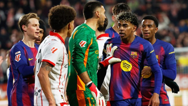 Barcelona's Lamine Yamal argues with Girona's Joel Roca and Axel Witsel during a Spanish La Liga soccer match between Girona and Barcelona in Girona, Spain, Monday, Feb. 16, 2026. (AP Photo/Joan Monfort)