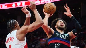 Detroit Pistons' Cade Cunningham (2) is stopped at the net by Toronto Raptors' Scottie Barnes (4) during second half NBA basketball action in Toronto, on Wednesday, Feb. 11, 2026. (Sammy Kogan/CP)