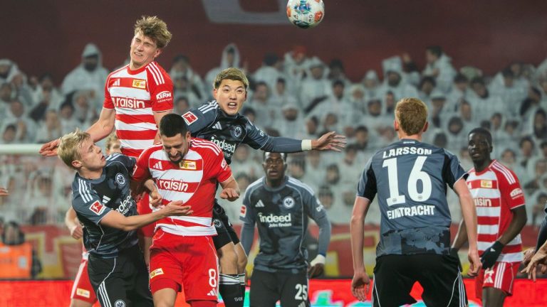 Union Berlin's Aljoscha Kemlein, top left, and Eintracht Frankfurt's Ritsu Doan battle for a head ball during a Bundesliga match, Friday, Feb. 6, 2026, in Berlin. (Soeren Stache/dpa via AP)