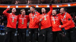 Team Jacobs (from left to right: Brad Jacobs, Marc Kennedy, Brett Gallant, Ben Hebert, Michael Caione, and coach Paul Webster) celebrates winning Olympic trials over Team Dunstone in Halifax on Saturday, November 29, 2025. (Photo by Darren Calabrese/CP)