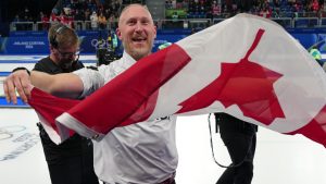 Canada's Brad Jacobs celebrates defeating Britain in a men's curling gold medal match, at the 2026 Winter Olympics, in Cortina d'Ampezzo, Italy, Saturday, Feb. 21, 2026. (Misper Apawu/AP)