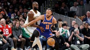 New York Knicks guard Jalen Brunson, right, maneuvers the ball around Boston Celtics guard Jaylen Brown, left, during the first half of an NBA basketball game, Sunday, Feb. 8, 2026, in Boston. (Mark Stockwell/AP)