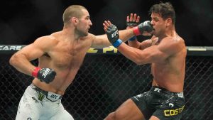 Sean Strickland, left, punches Brazil's Paulo Costa during the second round of a middleweight bout at the UFC 302 mixed martial arts event Saturday, June 1, 2024, in Newark, N.J. Strickland won the fight. (Frank Franklin II/AP)