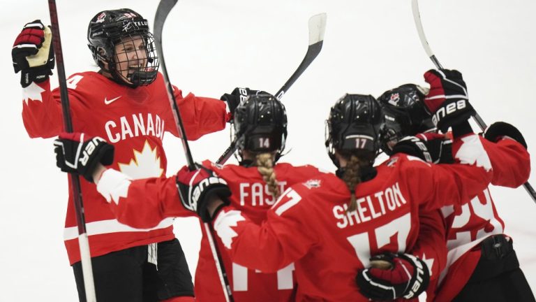 Marie-Philip Poulin of Canada, right, celebrates with teammates after scoring her sides second goal during the semi final match between Canada and Finland at the Women's Ice Hockey Championships in Ceske Budejovice, Czech Republic, Saturday, April 19, 2025. (AP Photo/Petr David Josek)