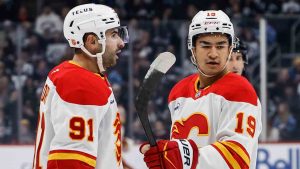 Calgary Flames' Nazem Kadri (91) and Zayne Parekh (19) celebrate Kadri's goal against the Winnipeg Jets during first period NHL action in Winnipeg on Friday, October 24, 2025. (John Woods/CP)