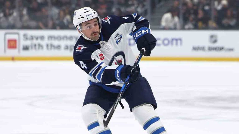 Winnipeg Jets defenseman Neal Pionk (4) passes the puck during the first period of an NHL hockey game against the Los Angeles Kings, Tuesday, Nov. 4, 2025, in Los Angeles. (Jessie Alcheh./AP)