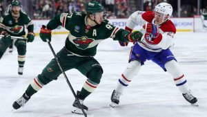 Minnesota Wild left wing Kirill Kaprizov, left, skates with the puck as Montréal Canadiens defenseman Kaiden Guhle (21) defends during the third period of an NHL hockey game Monday, Feb. 2, 2026, in St. Paul, Minn. (Matt Krohn/AP)