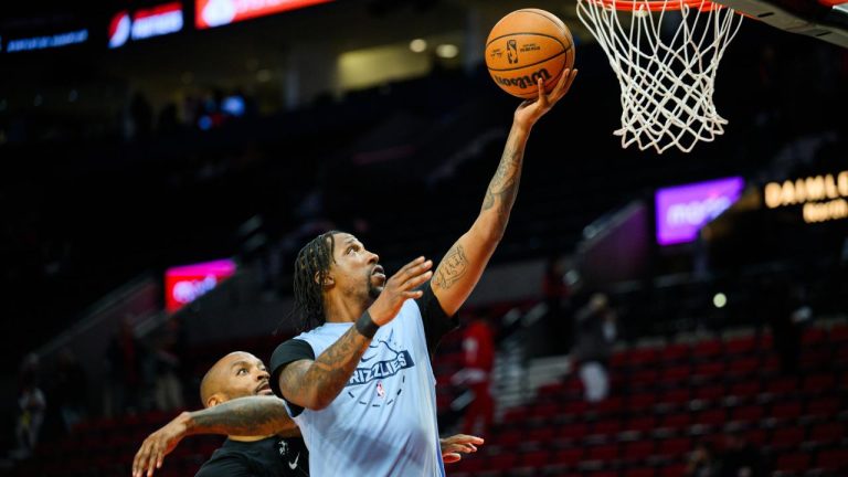 Memphis Grizzlies guard Kentavious Caldwell-Pope, right, warms up before NBA basketball game against the Portland Trail Blazers, Friday, Feb. 6, 2026, in Portland, Ore. (Molly J. Smith/ AP)