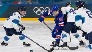 United States' Alex Carpenter, 2nd left, vies for the puck during a preliminary round match of women's ice hockey between the United States and Finland at the 2026 Winter Olympics, in Milan, Italy, Saturday, Feb. 7, 2026. (AP Photo/Petr David Josek)