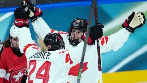 Canada’s Marie-Philip Poulin (29) and Natalie Spooner (24) celebrate a goal against Switzerland during the second period of a preliminary round women's hockey game at the Milan Cortina Winter Olympics, in Milan, on Saturday, Feb. 7, 2026. THE CANADIAN PRESS/Darryl Dyck