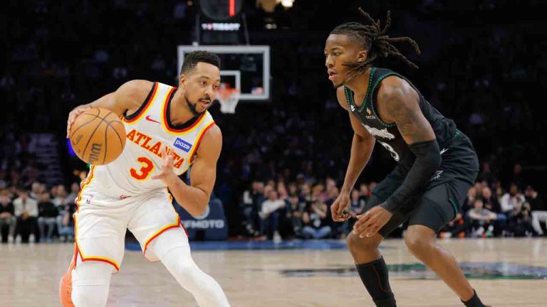 Atlanta Hawks guard CJ McCollum, left, drives while Minnesota Timberwolves guard Ayo Dosunmu, right, defends during the first half of an NBA basketball game, Monday, Feb. 9, 2026, in Minneapolis. (Bailey Hillesheim/AP)