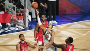 World center Victor Wembanyama, of France, shoots over USA Stars guard Devin Booker, left, and forward Jalen Duren during the NBA All-Star basketball game Sunday, Feb. 15, 2026, in Inglewood, Calif. (AP Photo/Jae C. Hong)