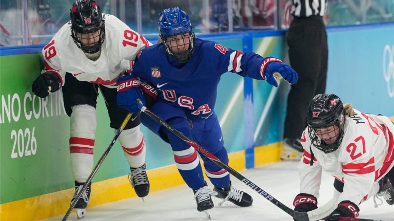 United States' Caroline Harvey (4) challenges with Canada's Brianne Jenner (19) and Canada's Emma Maltais (27) during a women's ice hockey gold medal game between the United States and Canada at the 2026 Winter Olympics, in Milan, Italy, Thursday, Feb. 19, 2026. (AP Photo/Hassan Ammar)