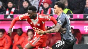 Bayern Munich's Alphonso Davies, left, and Frankfurt's Nnamdi Collins in action during the Bundesliga soccer match between Bayern Munich and Eintracht Frankfurt in Munich, Germany, Saturday Feb. 21, 2026. (Harry Langer/dpa via AP)