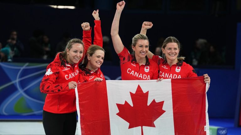 Canada's Rachel Homan, Tracy Fleury, Sarah Wilkes and Emma Miskew celebrate winning their women's curling bronze medal match against the United States, at the 2026 Winter Olympics, in Cortina d'Ampezzo, Italy, Saturday, Feb. 21, 2026. (AP Photo/Fatima Shbair)