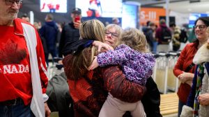 Canadian curler and bronze medalist in the Olympic Winter Games Emma Miskew, left, hugs her mother Jean Miskew as she is greeted by friends and family at the Ottawa International Airport after competing in the Olympic Winter Games in Ottawa, on Monday, Feb. 23, 2026. (Spencer Colby/CP)
