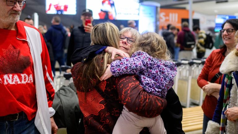 Canadian curler and bronze medalist in the Olympic Winter Games Emma Miskew, left, hugs her mother Jean Miskew as she is greeted by friends and family at the Ottawa International Airport after competing in the Olympic Winter Games in Ottawa, on Monday, Feb. 23, 2026. (Spencer Colby/CP)