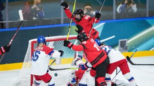 Canada's Julia Gosling (88) and Brianne Jenner (19) celebrate Gosling's goal against Czech Republic goalie Michaela Hesova (1) as Katerina Mrazova (16) watches during the first period of a preliminary round women's hockey game at the Milan Cortina Winter Olympics, in Milan, on Monday, February 9, 2026. (Darryl Dyck/CP)