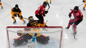 Canada's Brianne Jenner scores her side's opening goal during a women's ice hockey quarterfinal game between Canada and Germany at the 2026 Winter Olympics, in Milan, Italy, Saturday, Feb. 14, 2026. (AP/Darko Bandic, Pool)