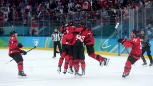 Team Canada players celebrate Mitch Marner's game-winning goal during overtime of a quarterfinal men's hockey game against Czechia at the 2026 Winter Olympics, in Milan, on Wednesday, Feb. 18, 2026. (Darryl Dyck/CP)