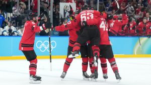 Canada defenceman Shea Theodore (27) celebrates his goal against Finland with teammates during third period men's Olympic semifinal hockey action at the 2026 Milan Cortina Winter Olympics in Milan, Italy on Friday, Feb. 20, 2026. (Nathan Denette/CP)