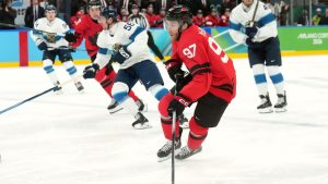 Canada forward Connor McDavid (97) breaks away during first period Men's Olympic semifinal ice hockey action against Finland, at the 2026 Milan Cortina Winter Olympics in Milan, Friday, Feb. 20, 2026. (Nathan Denette/CP)