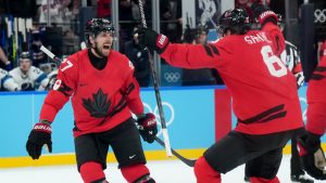 Canada defenceman Shea Theodore (27) celebrates his goal with Canada defenceman Travis Sanheim (6) during third period men's Olympic semifinal hockey action against Finland at the 2026 Milan Cortina Winter Olympics in Milan, Italy on Friday, Feb. 20, 2026. (Nathan Denette/CP)