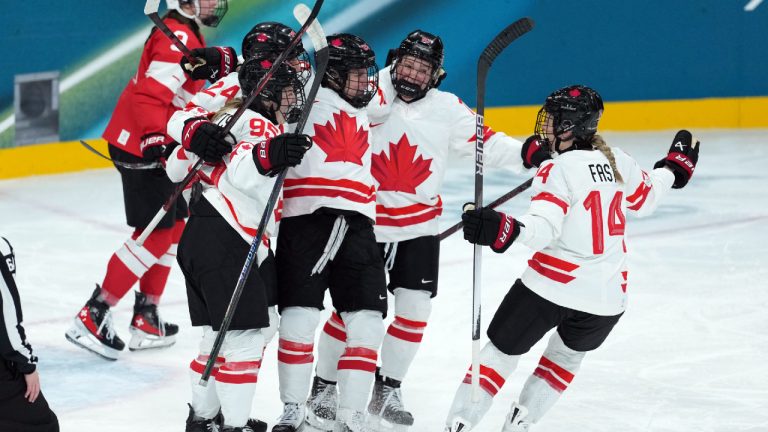 Canada’s Natalie Spooner (24) celebrates a goal with teammates against Switzerland during the second period of a preliminary round women's hockey game at the Milan Cortina Winter Olympics, in Milan, on Saturday, Feb. 7, 2026. (Darryl Dyck/CP)
