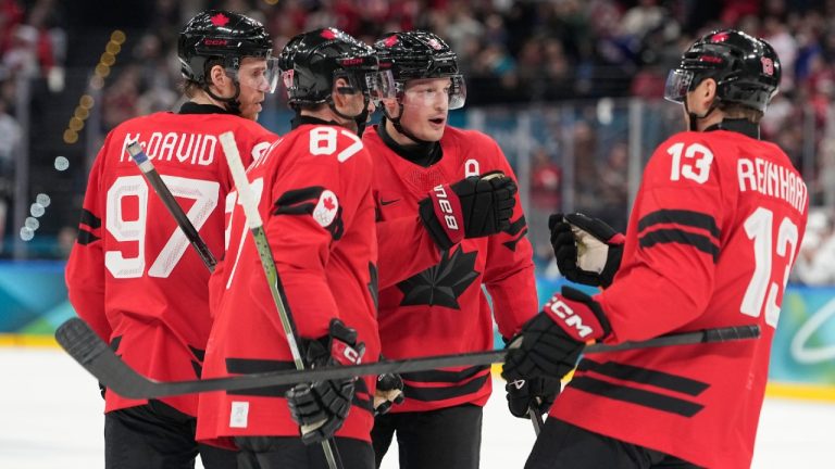 Canada's Cale Makar (8) celebrates with teammates Canada's Connor McDavid (97), Canada's Sidney Crosby (87), Canada's Sam Reinhart (13) after scoring during a preliminary round game of men's ice hockey between Canada and France at the 2026 Winter Olympics, in Milan, Italy, Sunday, Feb. 15, 2026. (Hassan Ammar/AP)