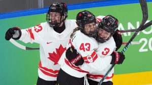 Canada's Kristin O'Neill (43) celebrates a goal with Jocelyne Larocque (3) and Erin Ambrose (23) during the second period of the women's gold medal hockey game at the 2026 Winter Olympics, in Milan, Thursday, Feb. 19, 2026. (Nathan Denette/CP)