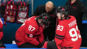 Canada's Sidney Crosby (87) is attended to after being injured during the second period of a men's ice hockey quarterfinal game between Canada and Czechia at the 2026 Winter Olympics, in Milan, Italy, Wednesday, Feb. 18, 2026. (Hassan Ammar/AP)