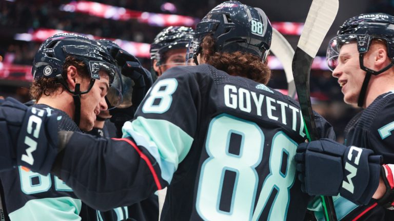 Seattle Kraken forward Tucker Robertson, left, celebrates after his goal with David Goyette (88) and other teammates during the first period of an NHL pre-season hockey game against the Calgary Flames, Monday, Sept. 25, 2023, in Seattle. (Jason Redmond/AP)
