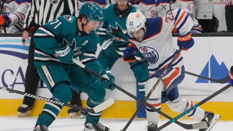 Edmonton Oilers centre Matt Savoie (22) skates toward with the puck against San Jose Sharks centre Macklin Celebrini (71) during the first period of an NHL hockey game in San Jose, Calif., Saturday, Feb. 28, 2026. (Jeff Chiu/AP)