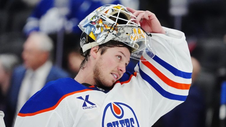 Edmonton Oilers goaltender Tristan Jarry adjusts his mask during a break in second period NHL action against the Toronto Maple Leafs in Toronto on Saturday, Dec. 13, 2025. (Frank Gunn/CP)