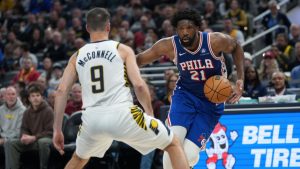Philadelphia centre Joel Embiid looks to move around Indiana guard T.J. McConnell during the first half of an NBA game in Indianapolis, Tuesday, Feb. 24, 2026. (AP/AJ Mast)