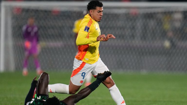 Nigeria's Daniel Bameyi falls while challenging Colombia's Emilio Aristizabal during a FIFA U-20 World Cup Group F soccer match at Fiscal Stadium in Talca, Chile, Sunday, Oct. 5, 2025. (Matias Delacroix/AP)