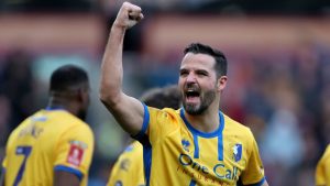 Mansfield Town's Stephen McLaughlin celebrates scoring during the English FA Cup fourth round match between Burnley and Mansfield Town in Burnley, England, Saturday Feb. 14, 2026. (Richard Sellers/PA via AP)