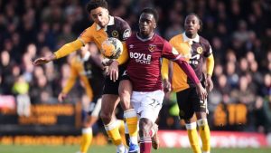 Burton Albion's Kain Adom, left, and West Ham United's Soungoutou Magassa in action during the English FA Cup fourth round match between Burton Albion and West Ham United in Burton upon Trent, England, Saturday Feb. 14, 2026. (Mike Egerton/PA via AP)