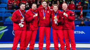 Team Canada’s Tyler Tardi, Ben Herbert, Brett Gallant, Marc Kennedy and Brad Jacobs celebrate winning a gold medal after defeating Team Great Britain in mens curling at the Milano Cortina 2026 Olympic Winter Games in Italy on Saturday, February 21, 2026. (Photo by Candice Ward/COC)