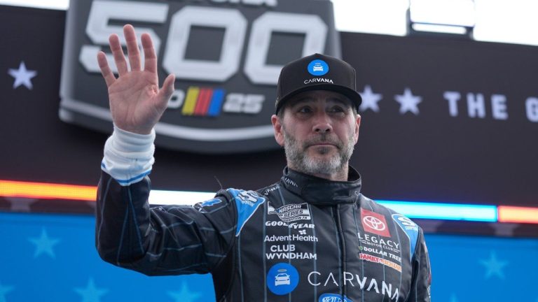 FILE - Jimmie Johnson waves during driver introductions before the NASCAR Daytona 500 auto race at Daytona International Speedway, Feb. 16, 2025, in Daytona Beach, Fla. (AP/John Raoux, File)