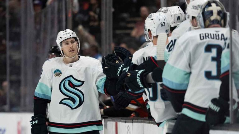 Seattle Kraken left wing Tye Kartye (12) celebrates his goal with the bench during the third period of an NHL hockey game against the Anaheim Ducks. (Kyusung Gong/AP)