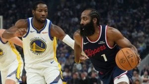 Los Angeles Clippers guard James Harden, right, drives to the basket against Golden State Warriors forward Jonathan Kuminga during an NBA basketball game in San Francisco, Tuesday, Oct. 28, 2025. (AP Photo/Jeff Chiu)