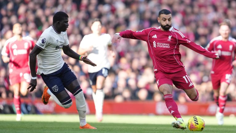 Liverpool's Mohamed Salah shoots by West Ham's El Hadji Malick Diouf during the Premier League soccer match between Liverpool and West Ham United in Liverpool, England, Saturday, Feb. 28, 2026. (AP Photo/Jon Super)