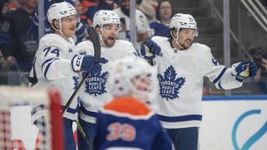 Toronto Maple Leafs' Bobby McMann (74), Matias Maccelli (63) and Marshall Rifai (83) celebrate a goal against the Edmonton Oilers during third period NHL action, in Edmonton on Tuesday, Feb. 3, 2026. (Jason Franson/CP)