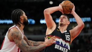 Denver Nuggets center Nikola Jokic (15), right, handles the ball as Chicago Bulls center Nick Richards (13) defends during the second half of an NBA basketball game Saturday, Feb. 7, 2026, in Chicago. (AP Photo/Erin Hooley)