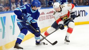 Tampa Bay Lightning defenceman Declan Carlile (67) and Florida Panthers centre Cole Schwindt (79) battle for the puck during the first period of an NHL hockey game Thursday, Feb. 5, 2026, in Tampa, Fla. (Chris O'Meara/AP)
