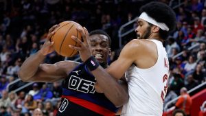 Detroit Pistons center Jalen Duren (0) drives to the basket against Cleveland Cavaliers center Jarrett Allen, right, during the first half of an NBA basketball game Friday, Feb. 27, 2026, in Detroit. (AP Photo/Duane Burleson)